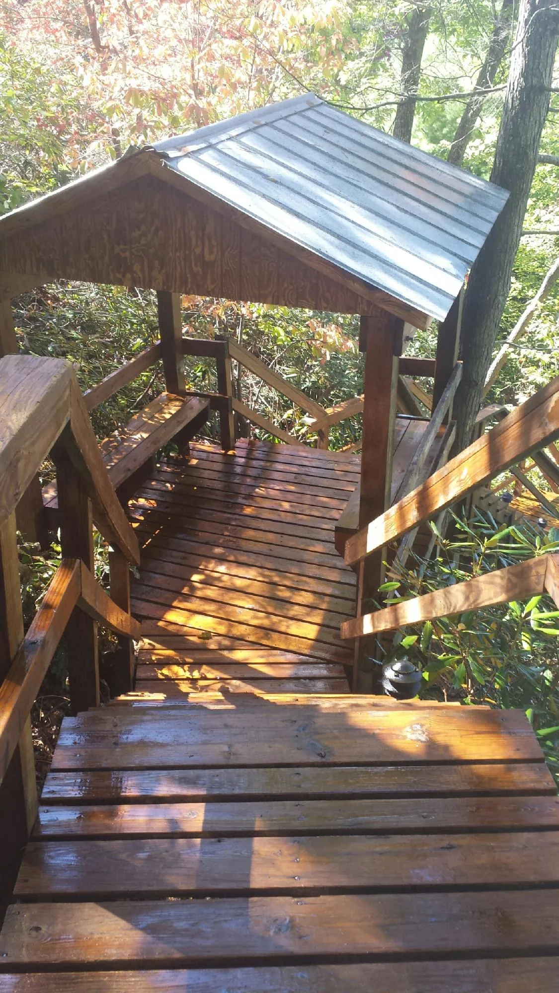 Freshly stained wood walkway and covered shelter with a metal roof in Northboro