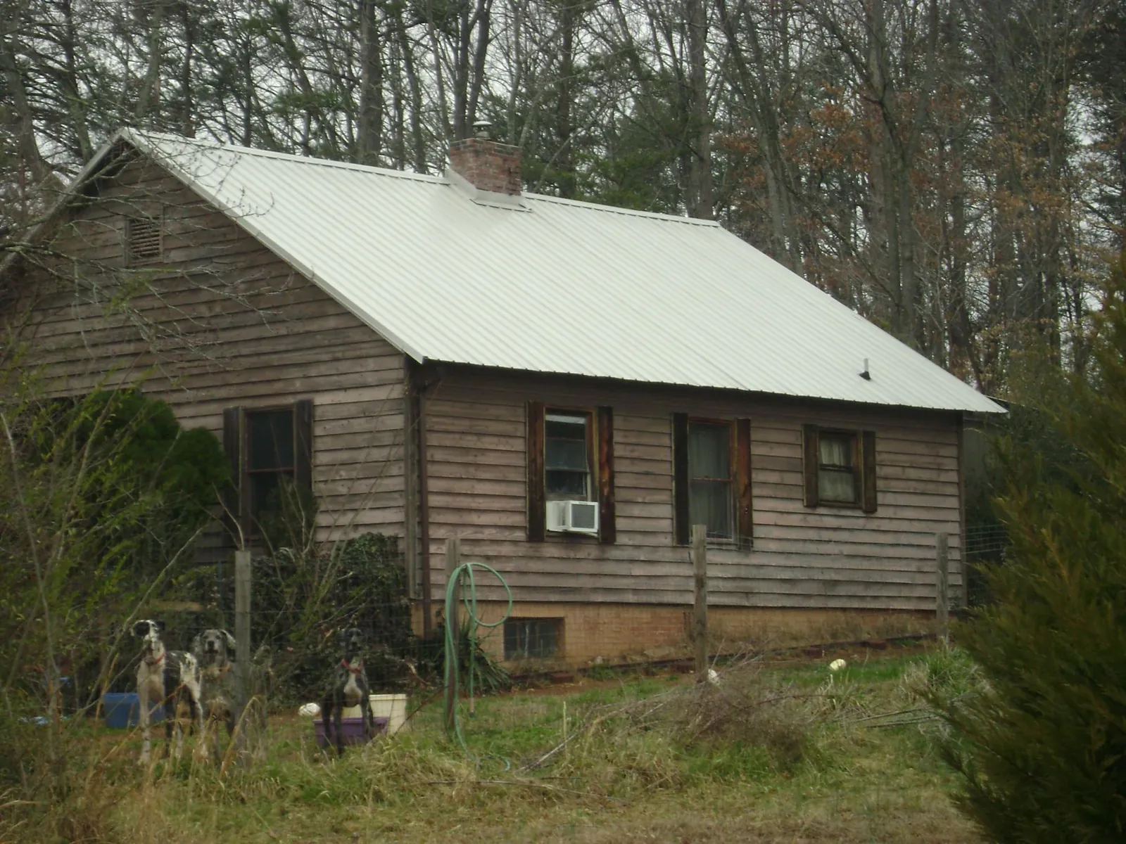 White metal roof on an old wood sided farmhouse, from a Metal Roof Installation job in Northboro